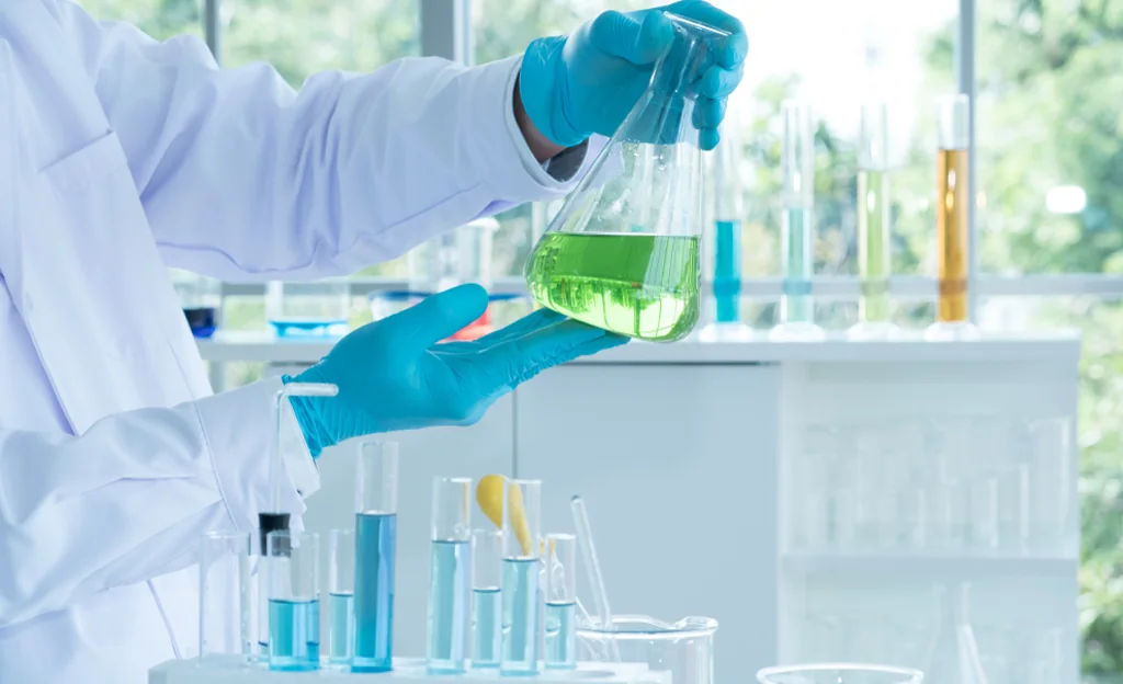 Scientist working with laboratory glassware